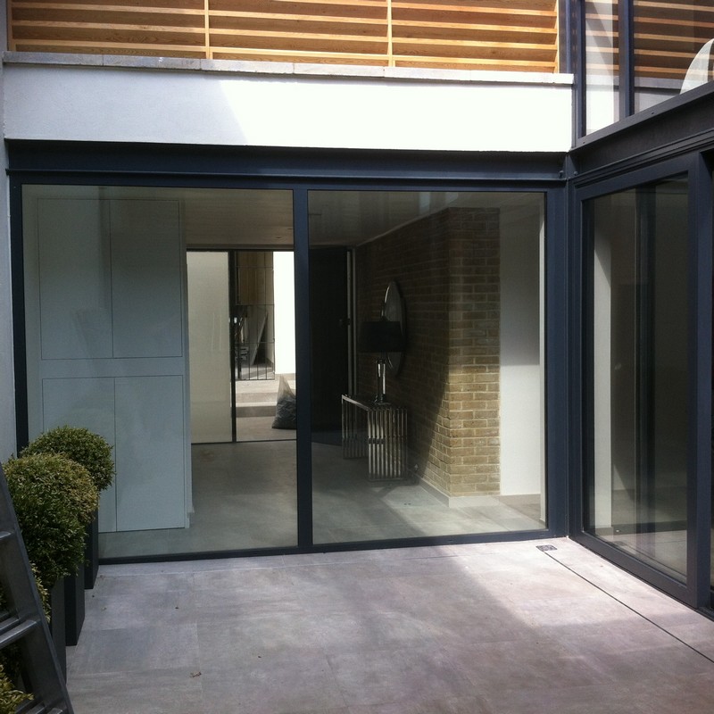 Floor-to-ceiling sliding doors opening to courtyard in Finchley Central