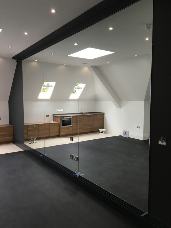 Frameless glass partition in loft conversion by Finchley Central glaziers