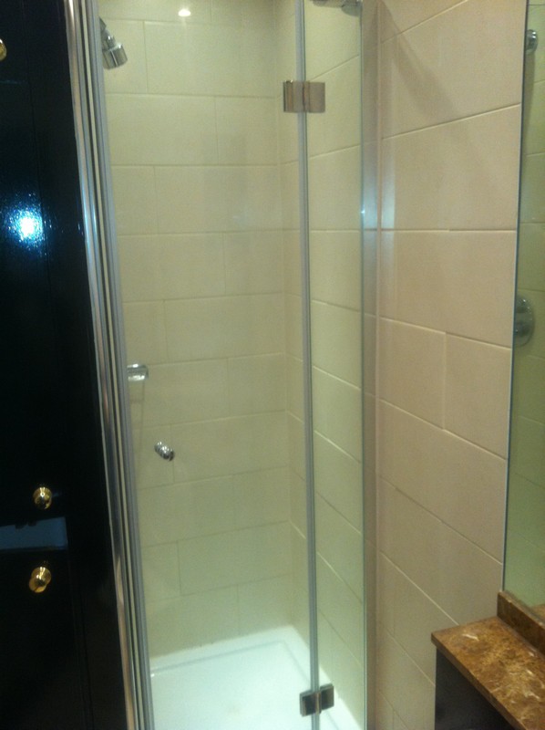 Frameless glass shower enclosure with chrome fittings in Finchley Central