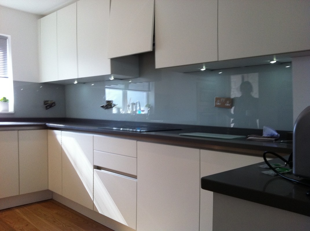Grey glass kitchen splashback with LED lighting in Finchley Central