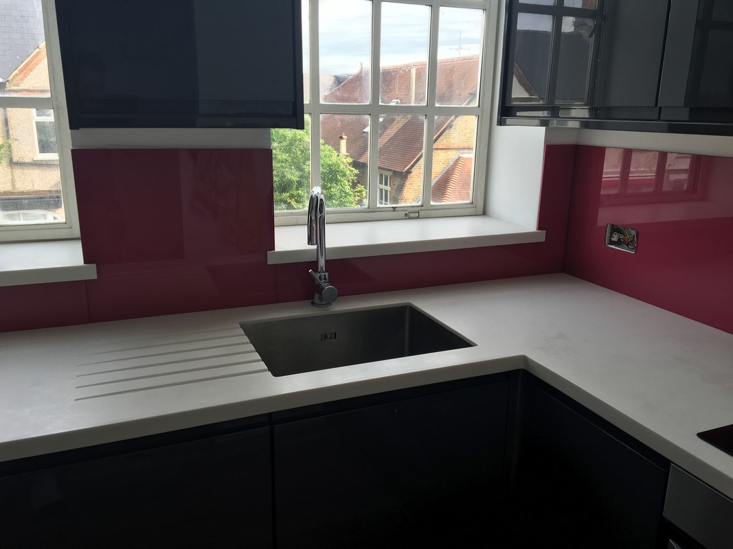 Deep plum coloured glass splashback in modern Finchley Central kitchen